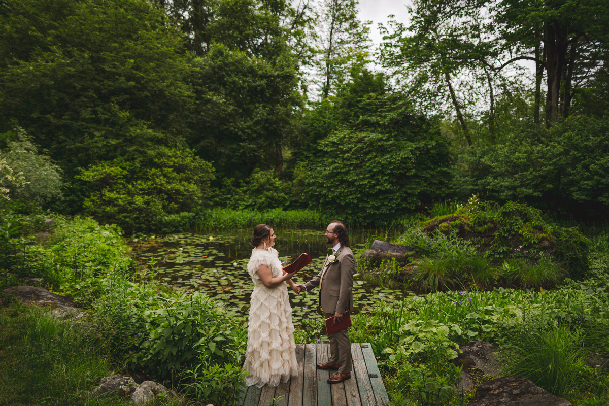 a bride and groom read their vows in the Berkshire botanical garden