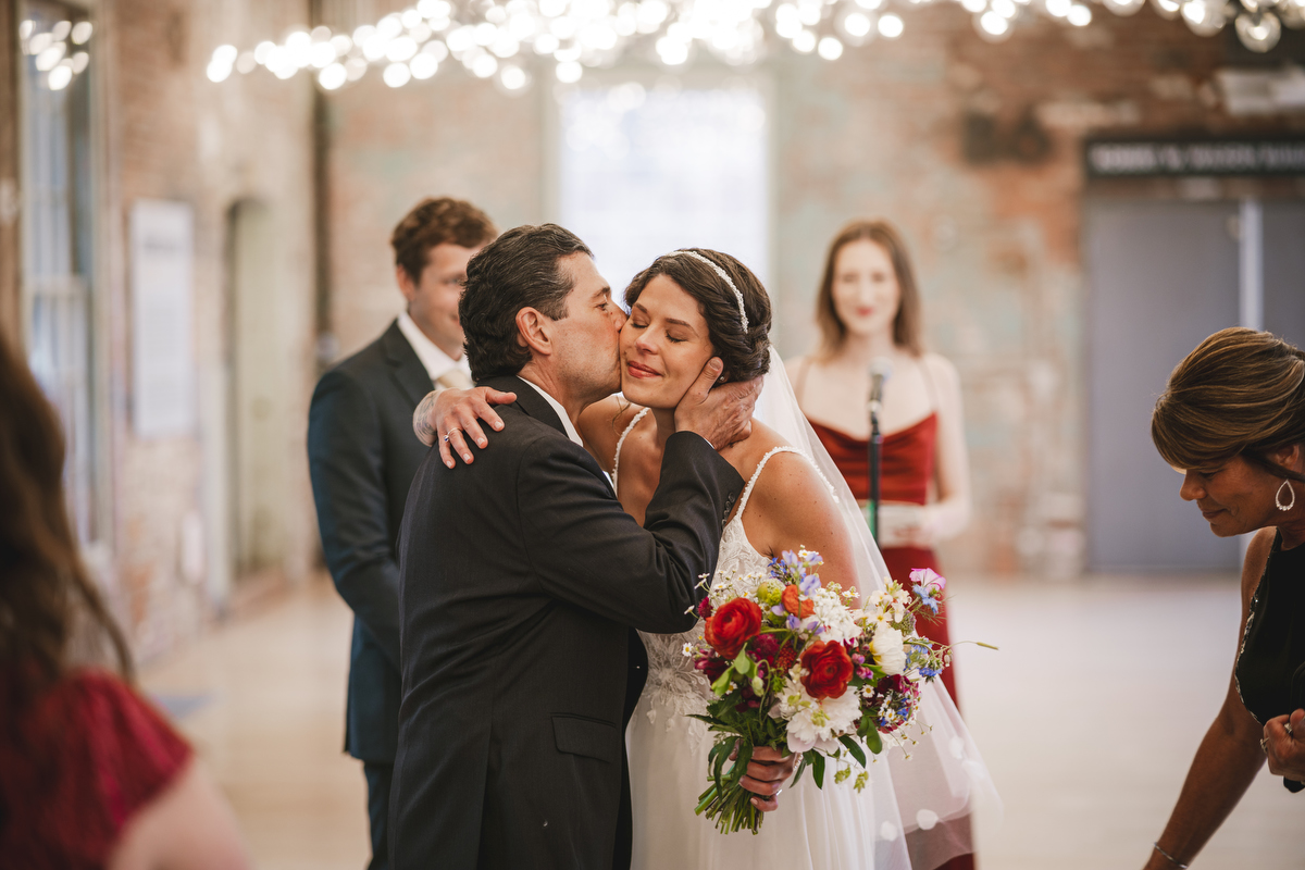 MASS MoCA bride hugs her father at the start of her wedding ceremony