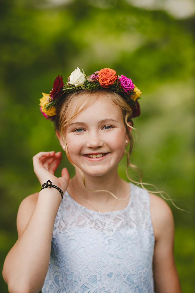 a flower girl touches her flower crown before a wedding in Montague
