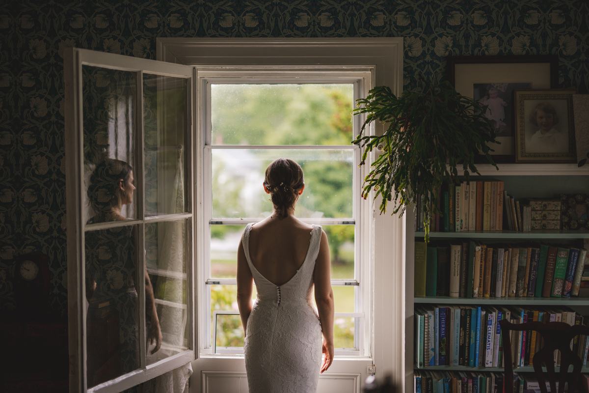 a bride looks out the window of an old house at Gloriosa & Co. in Ashfield 