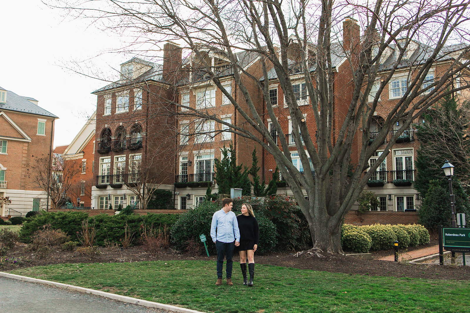 a couple standing in a park in old town alexandria
