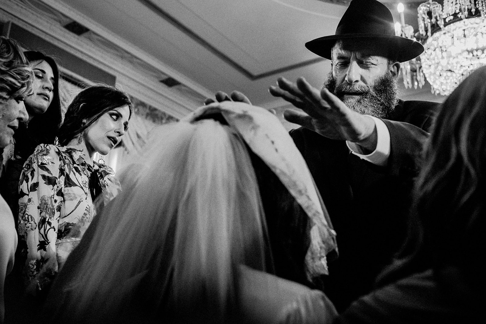bride receiving blessing from rabbi at bedeken ceremony in jewish wedding