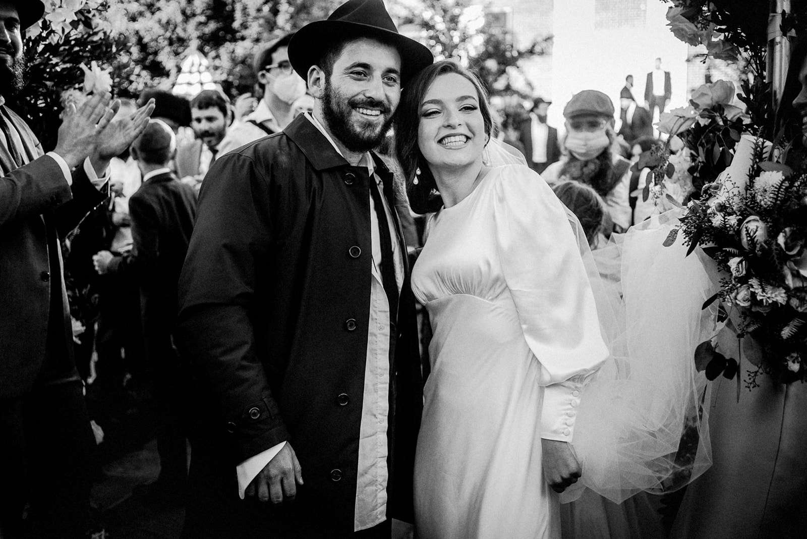 black and white image of bride and groom under chuppah after getting married at their orthodox jewish wedding