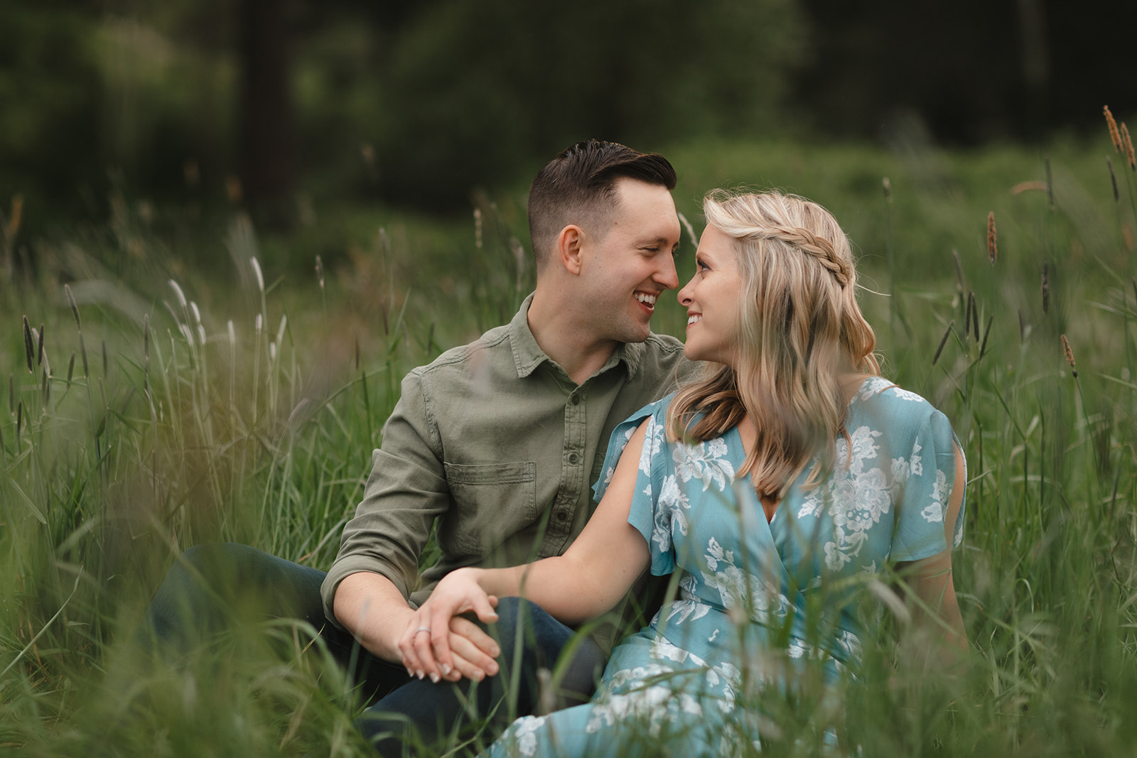 Engagement Session in Discovery Park Seattle. Couple sharing a moment in the grassy area. 