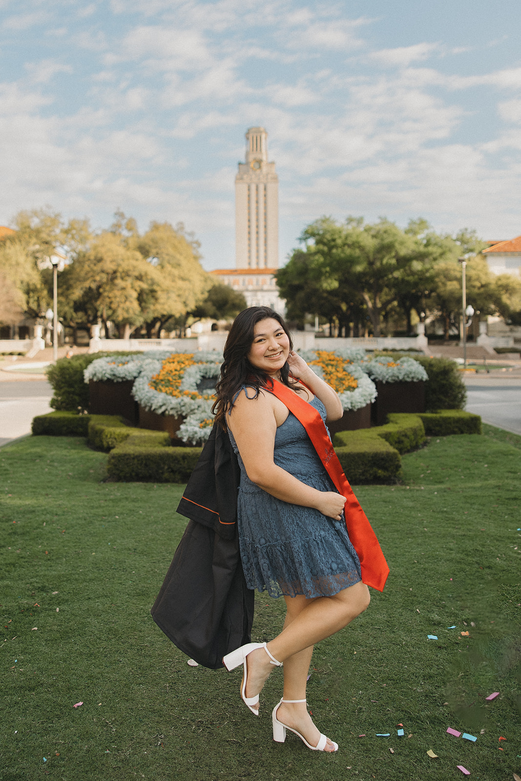 UT Austin senior pictures on the lawn with cap and gown