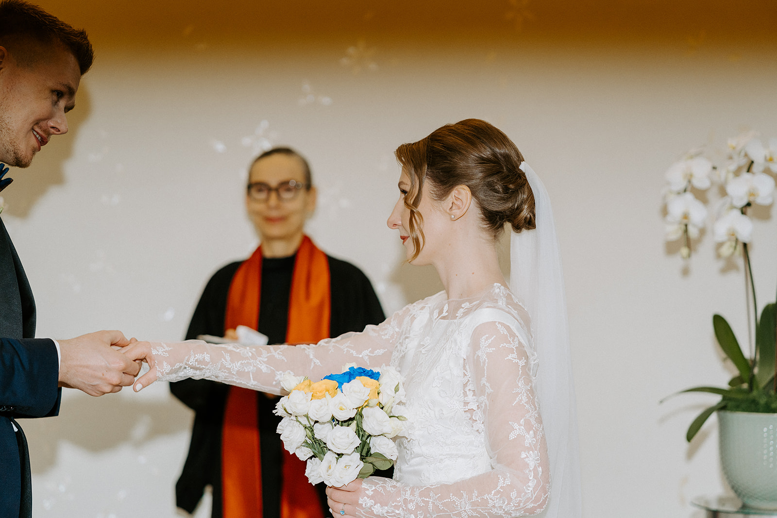A bride reaching her hand out to the groom.