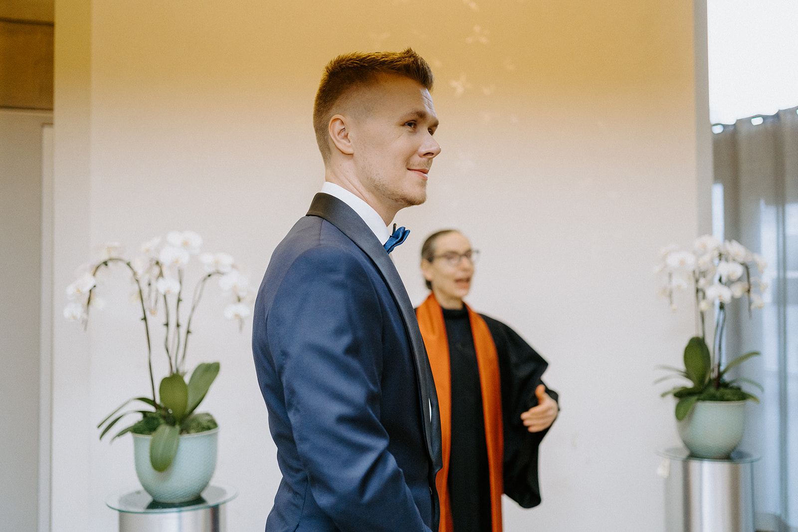 A groom standing at the alter.
