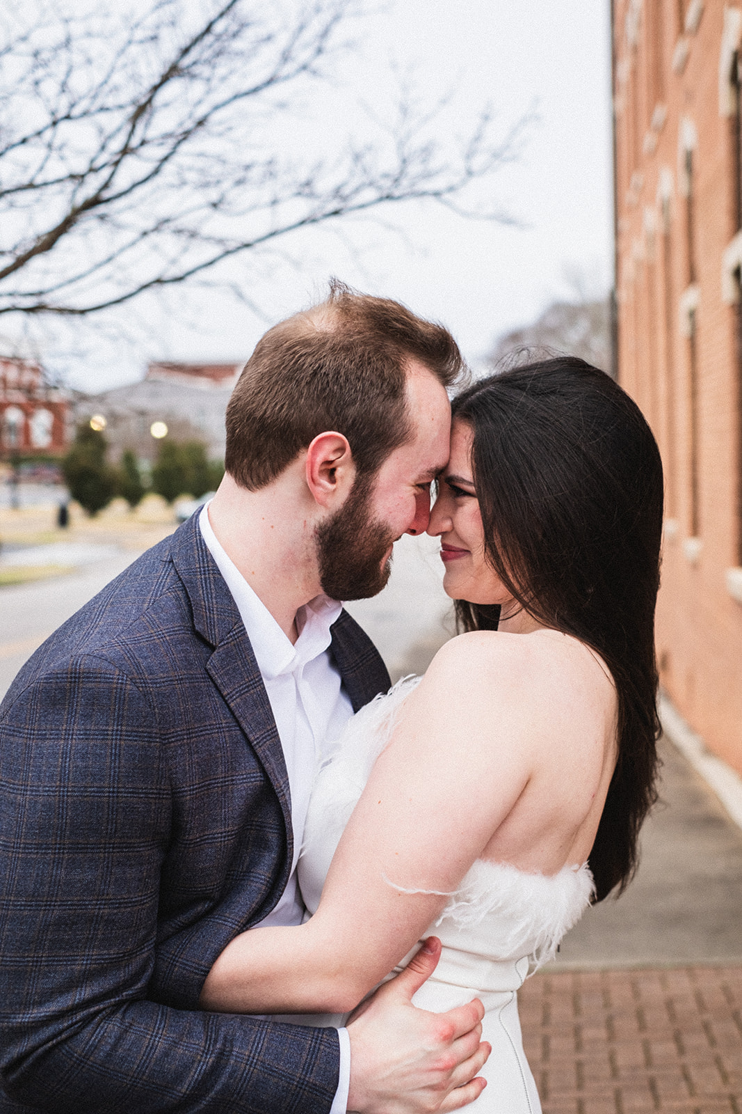 a couple in love embracing on a street corner of downtown opelika alabama
