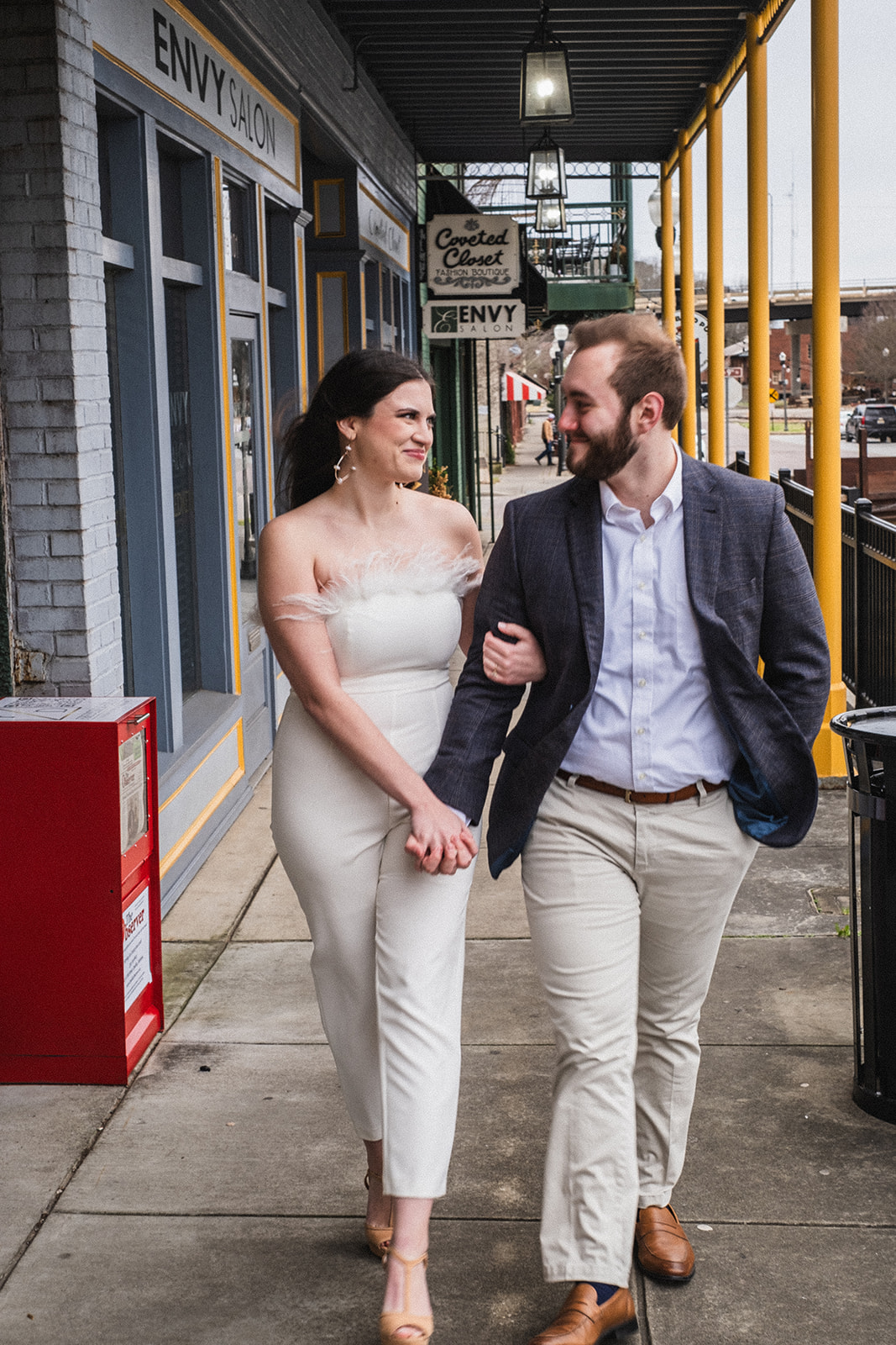 A couples engagement session in downtown Opelika Alabama walking along the historic streets. 