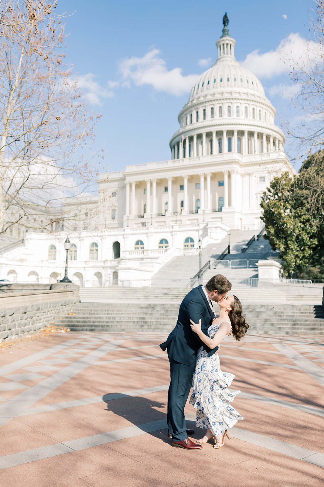 An engaged couple in front of the U.S. Capitol Building during their winter engagement session in Washington DC