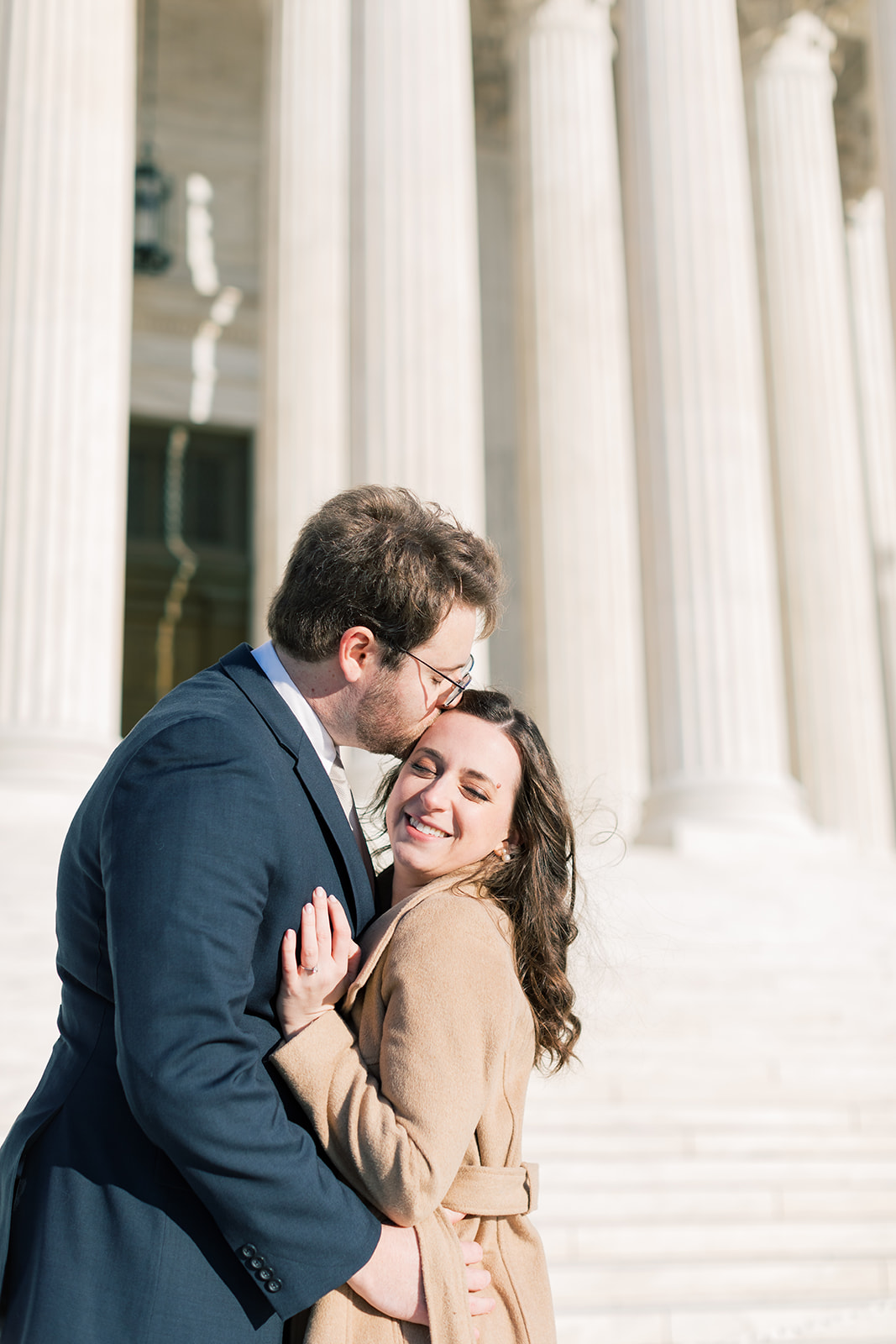 An engaged couple in front of the Supreme Court during their winter engagement session in Washington DC