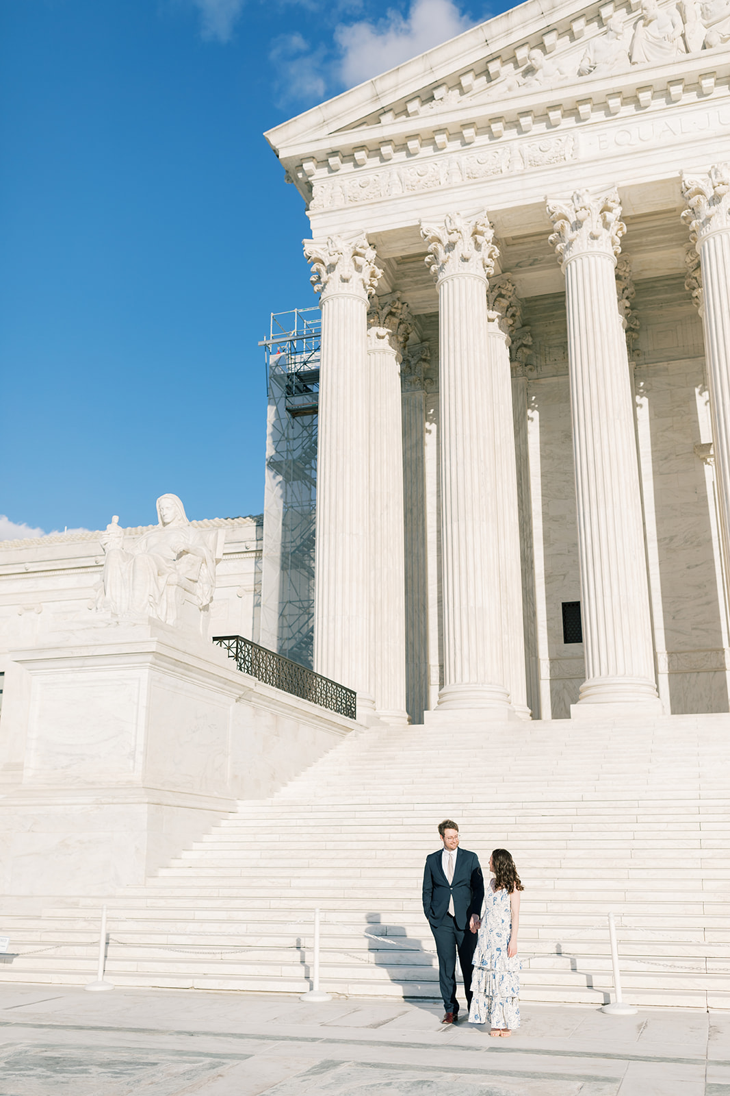 An engaged couple in front of the Supreme Court during their winter engagement session in Washington DC