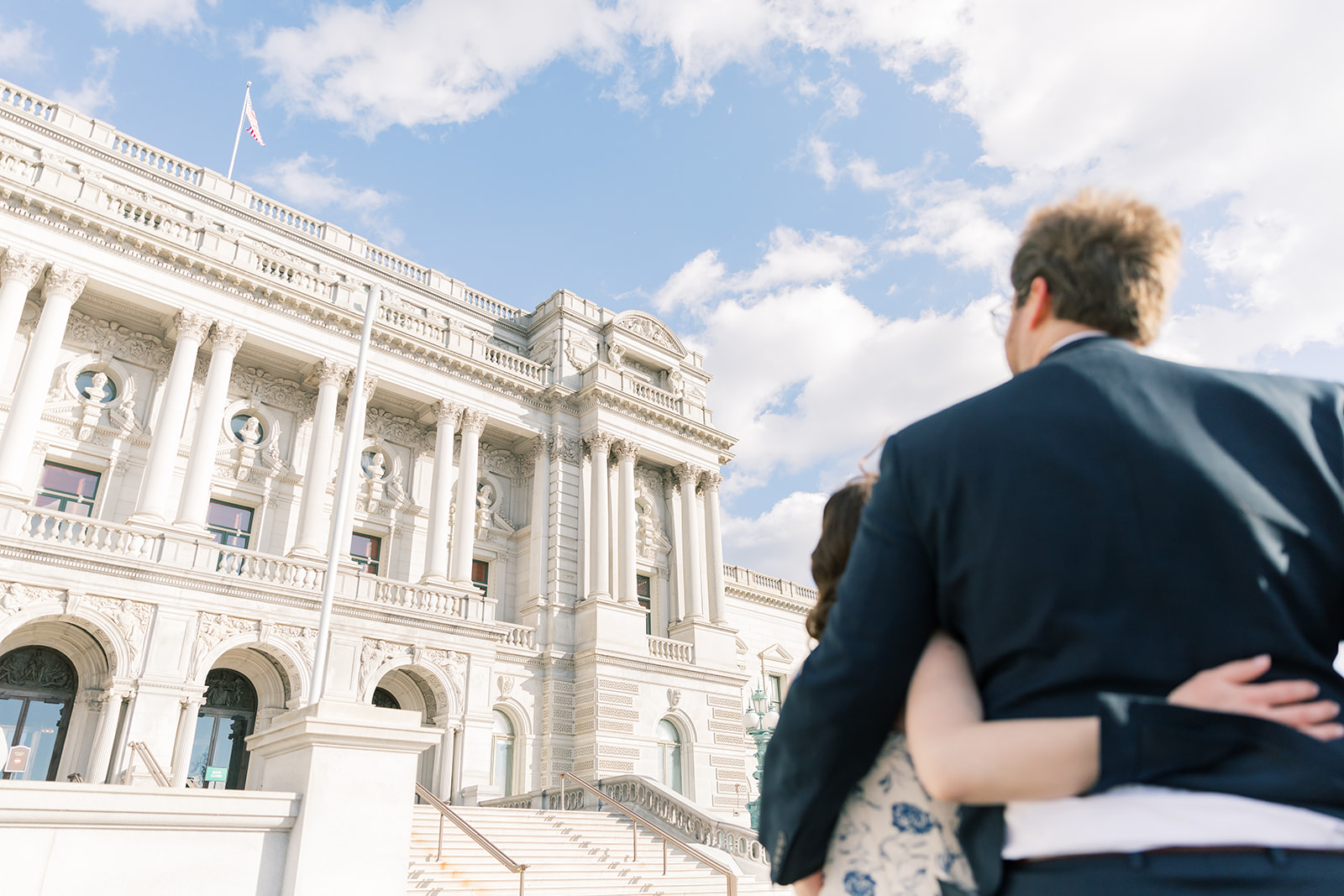 An engaged couple in front of the Library of Congress during their winter engagement session in Washington DC