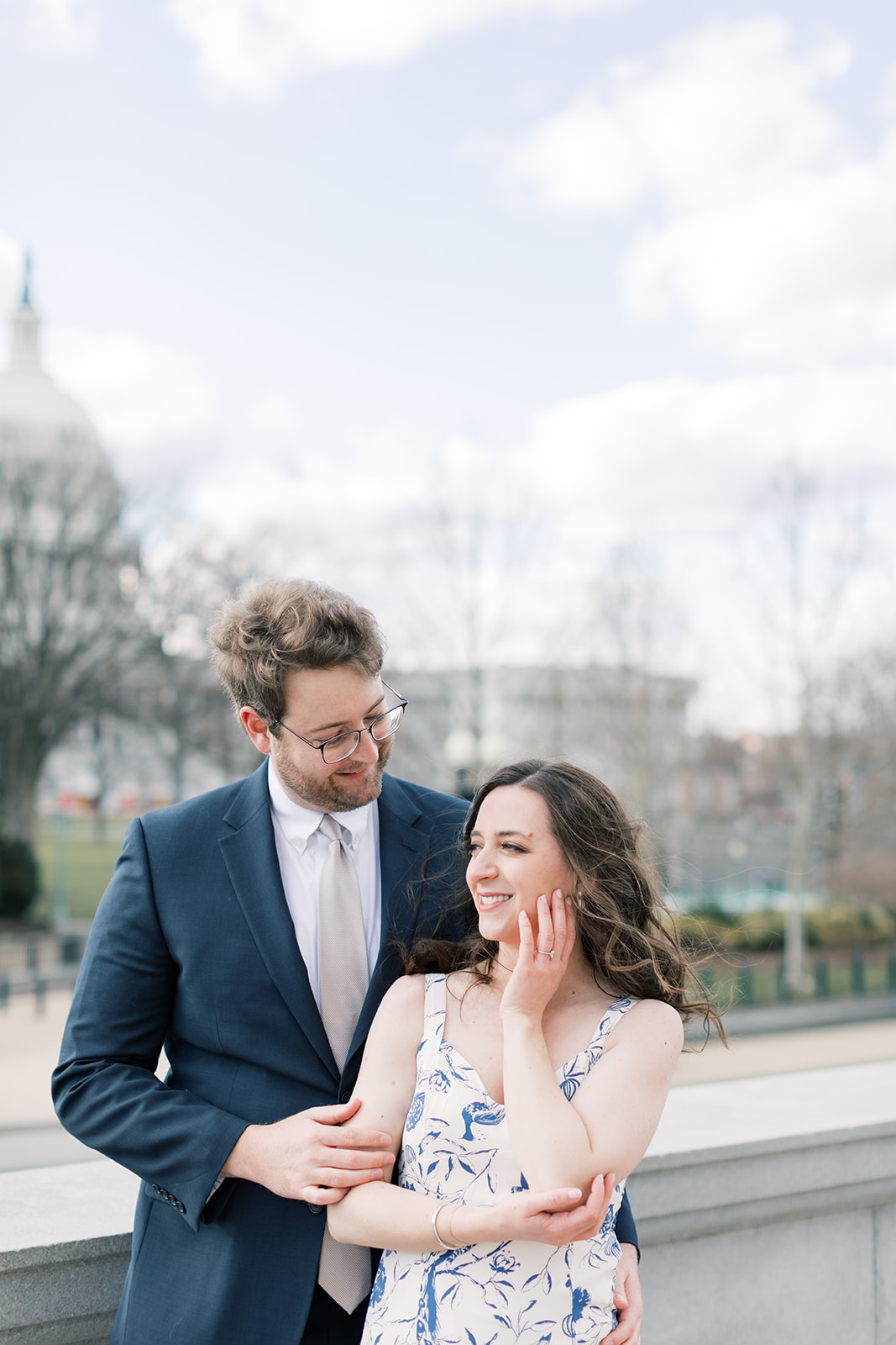 An engaged couple in front of the Library of Congress during their winter engagement session in Washington DC