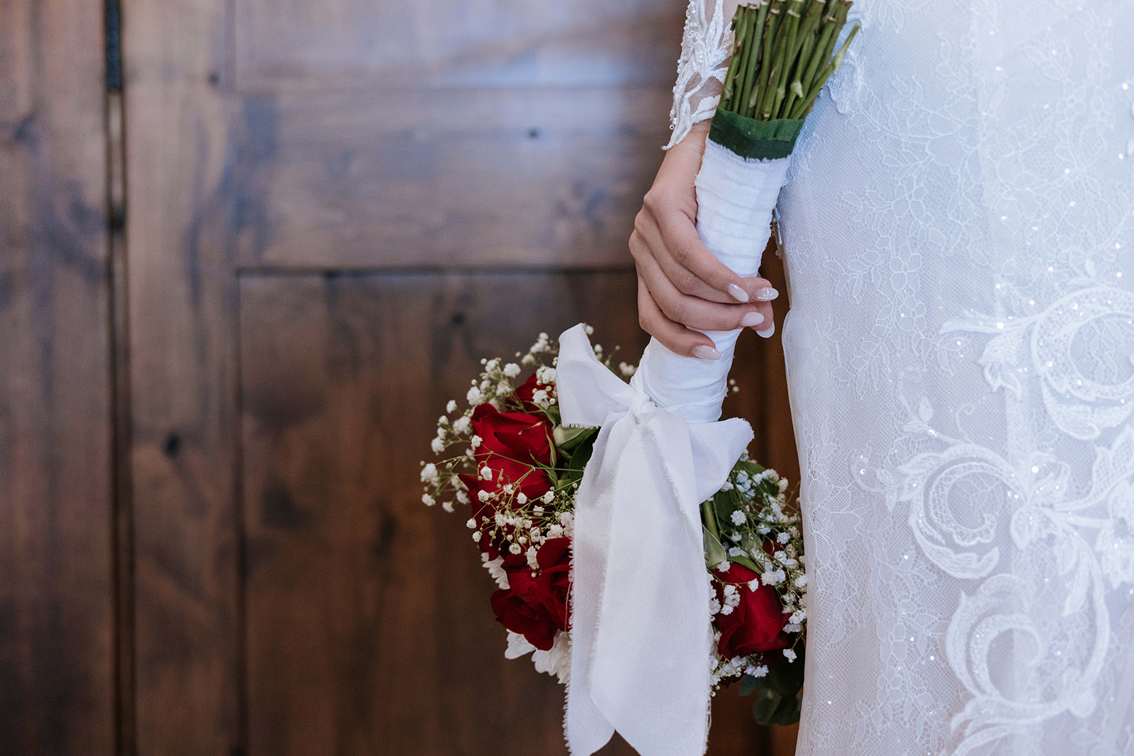 Bride Holding a Beautiful bouquet of red roses. 