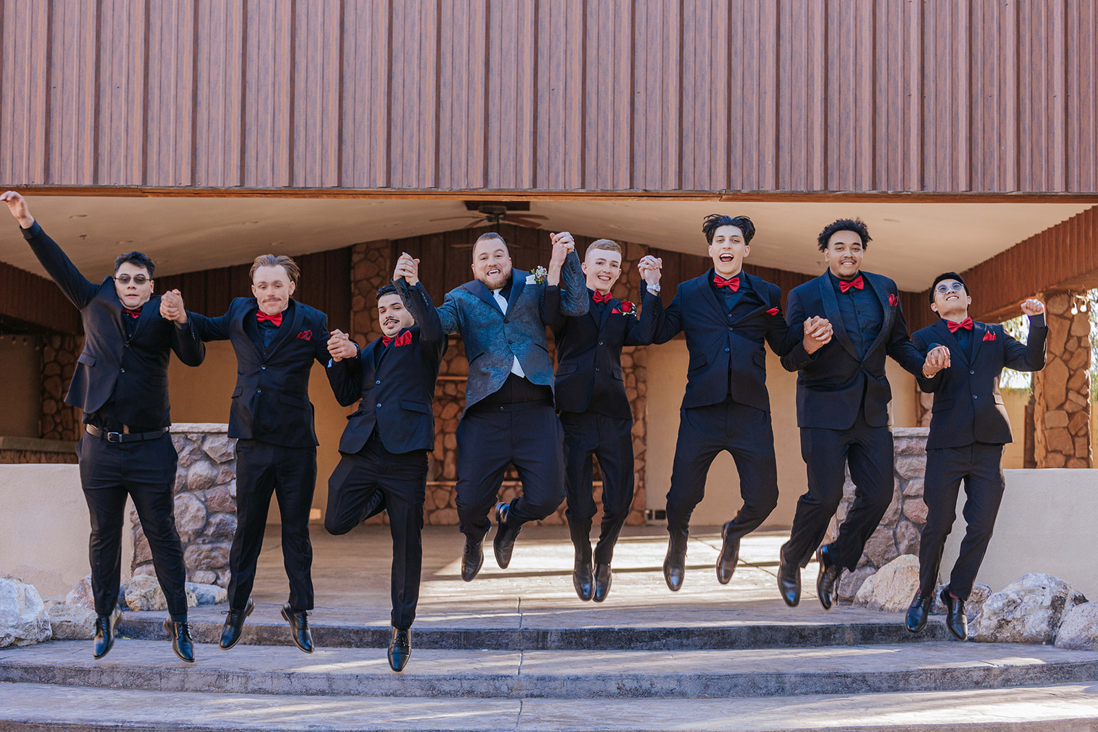 Groomsman Jumping in the air for their shot