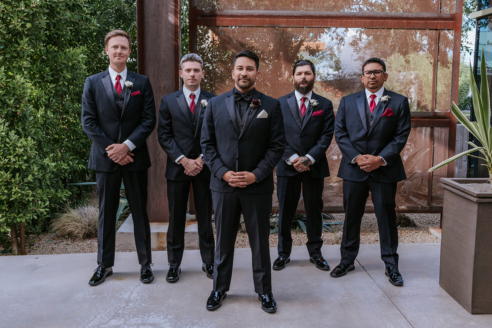 Groomsman posing for the camera with garden background