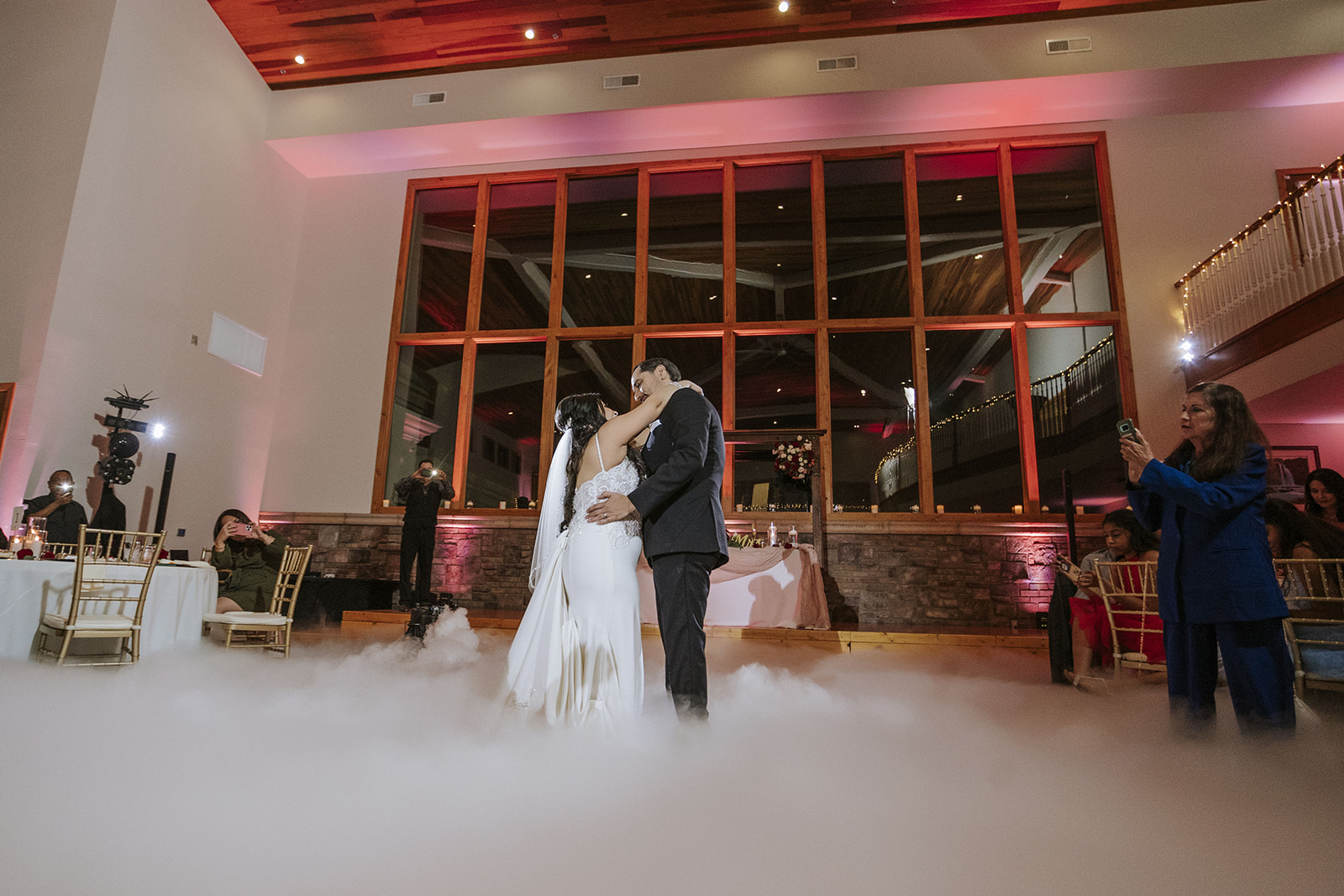 Bride and groom Dancing their first dance as husband and wife in a cloud of smoke.