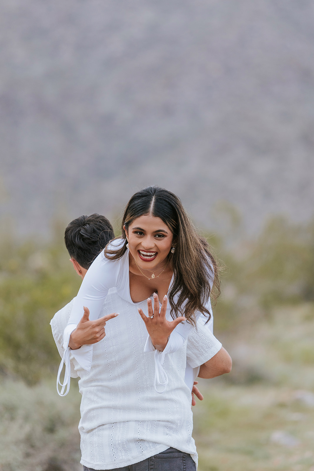 Bride showing the ring while being carried away. 