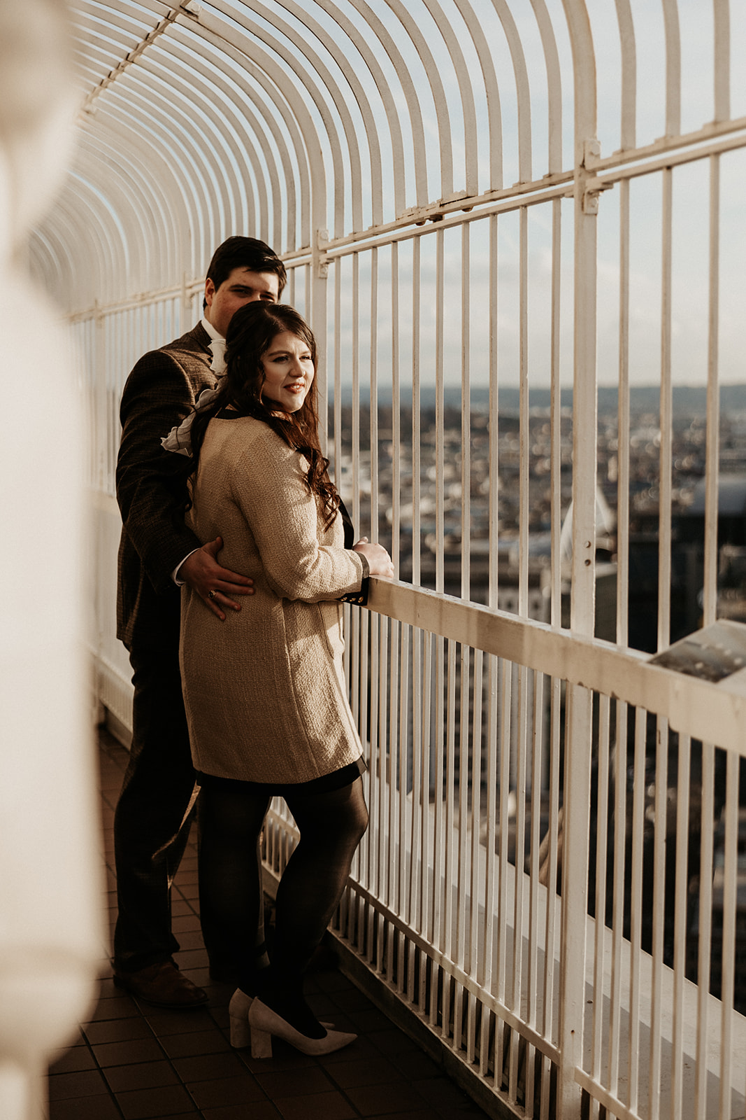 man and woman pose at smith tower in seattle