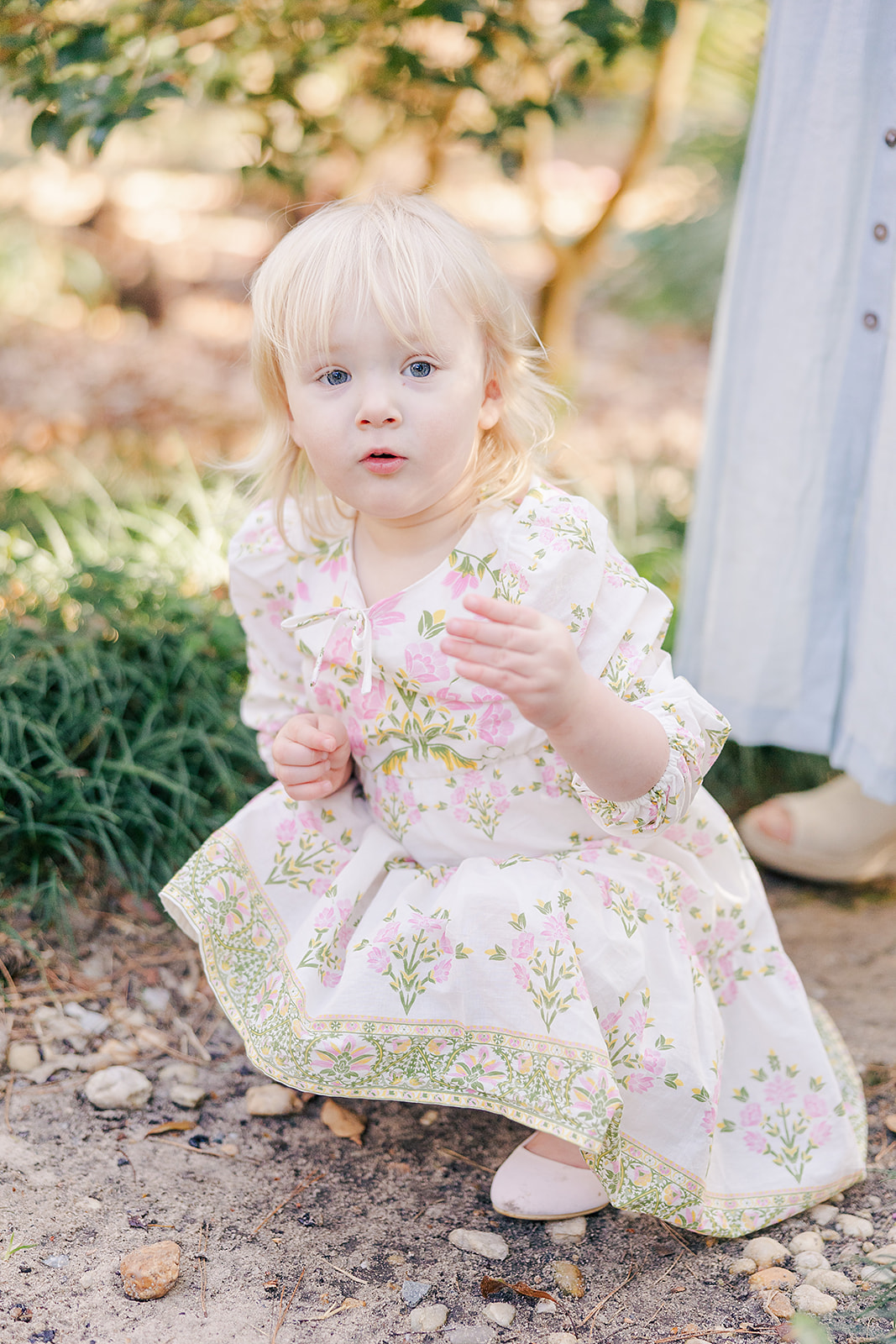 active toddler sibling in floral dress