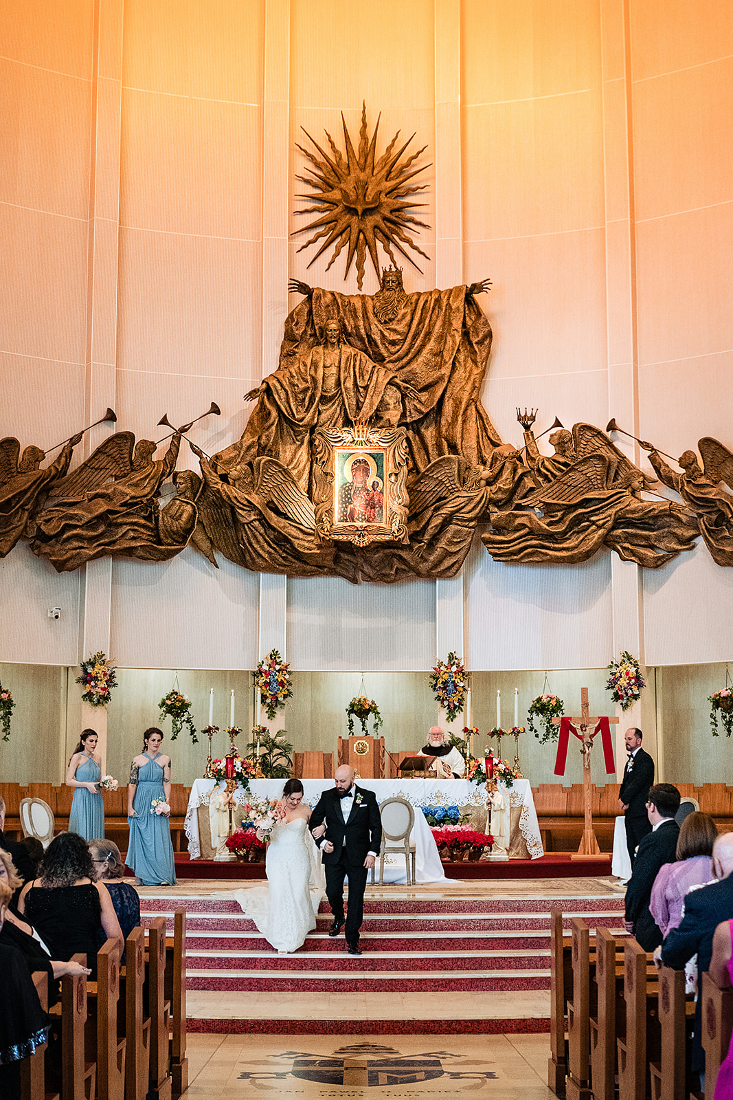 bridal and groom walking down the altar at national shrine of our lady of czestochowa church