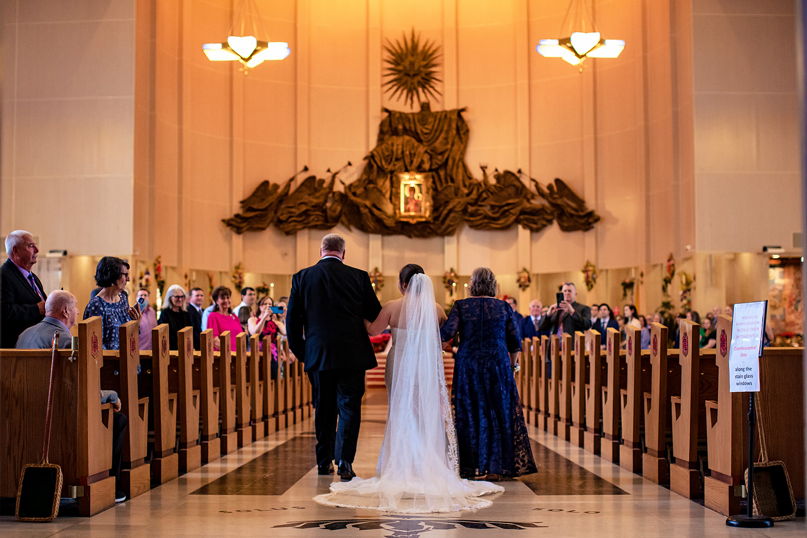 bridal walking down the aisle at national shrine of our lady of czestochowa church