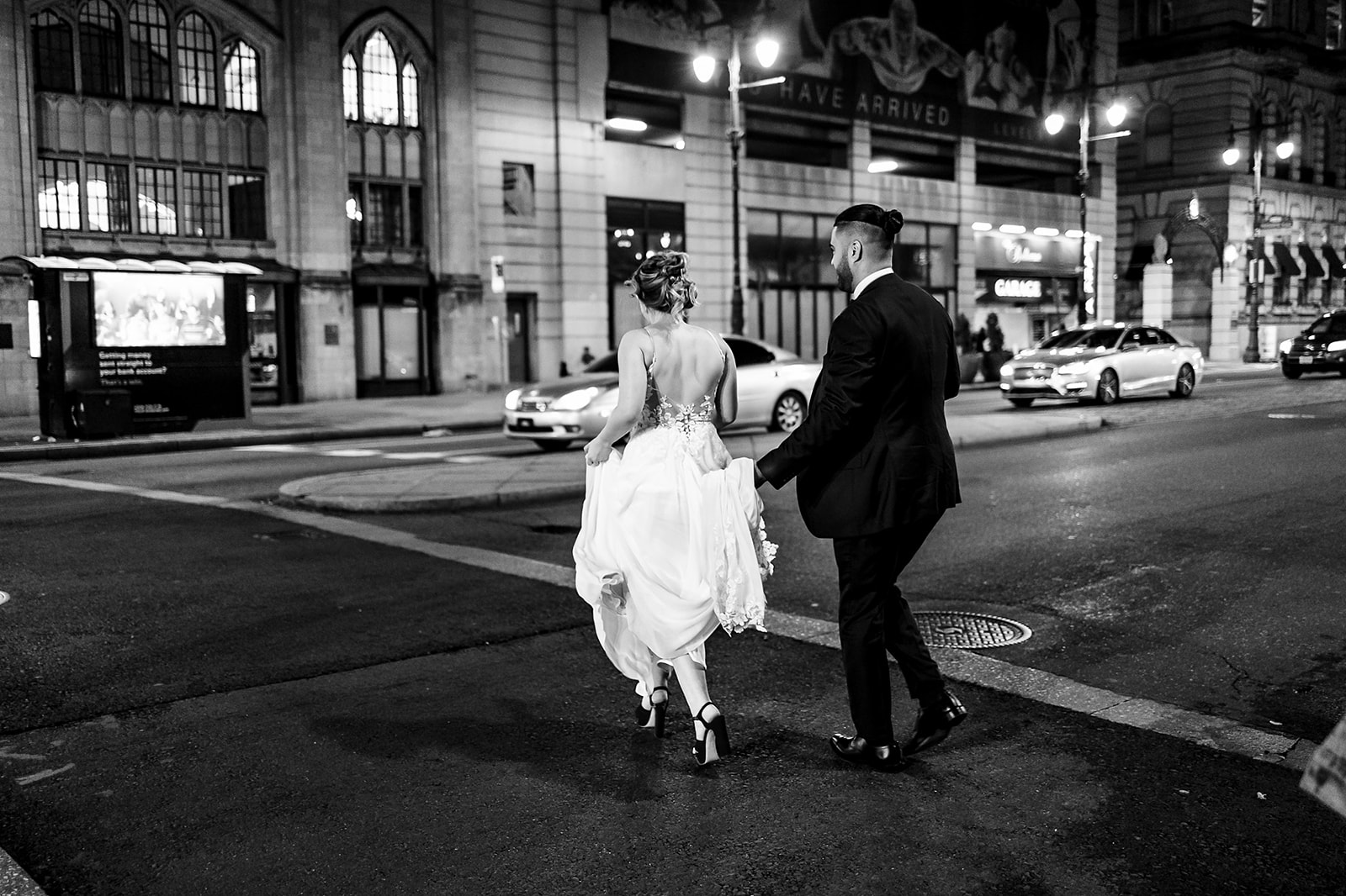 couple walking at night in philadelphia during their wedding
