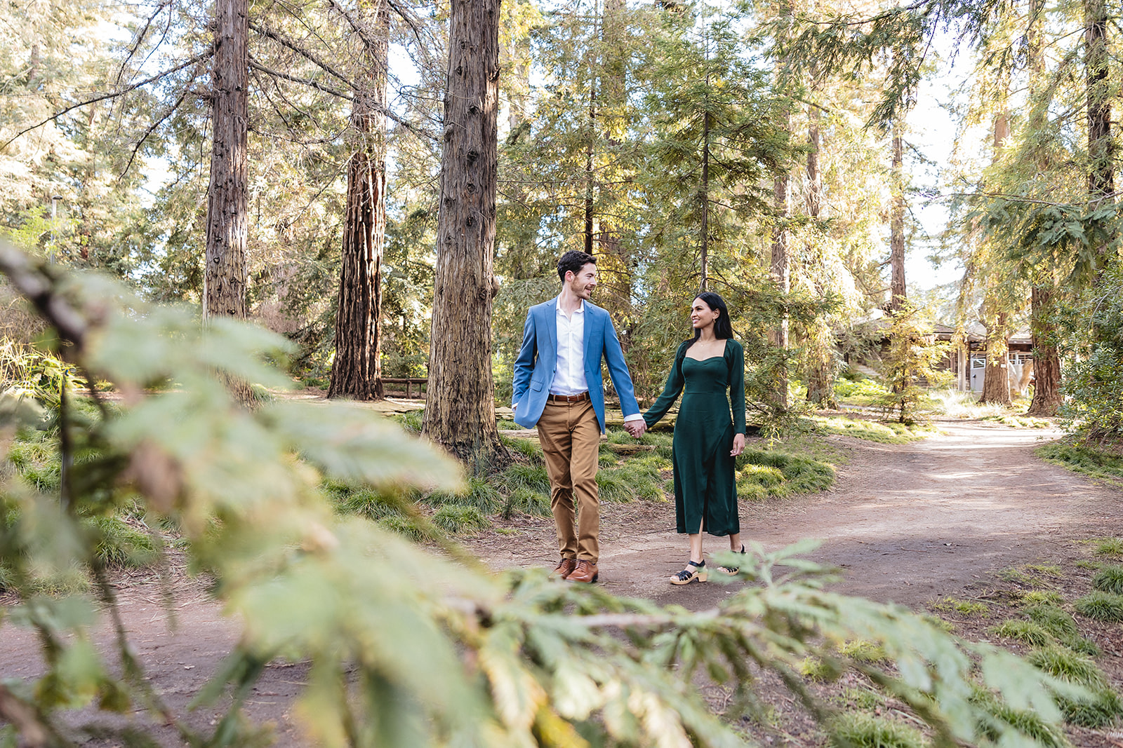 Couple walking in woods for their engagement shoot by Sacramento engagement photographer, philippe studio pro.