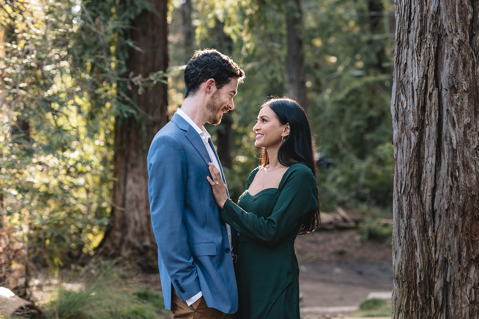 Close up of sacramento couple looking at each other lovingly in the middle of the woods.