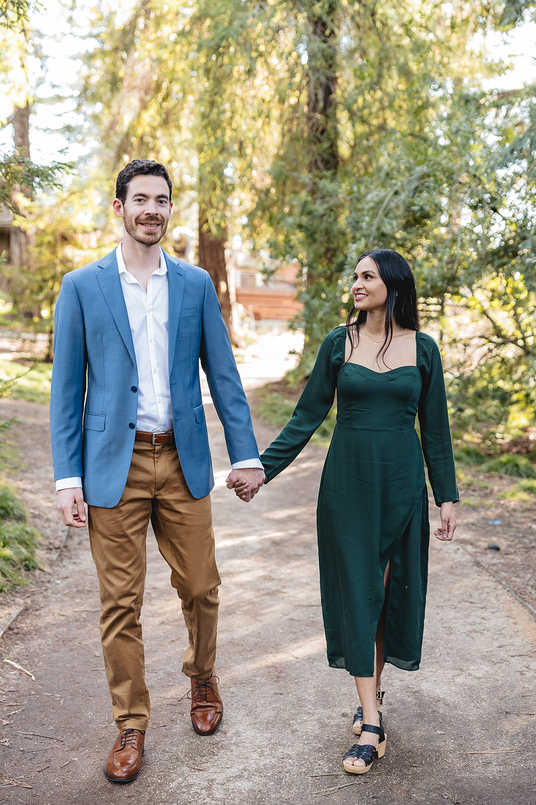 Engaged couple walking down a path at the uc davis arboretum. Photo by wedding photographer philippe studio pro.