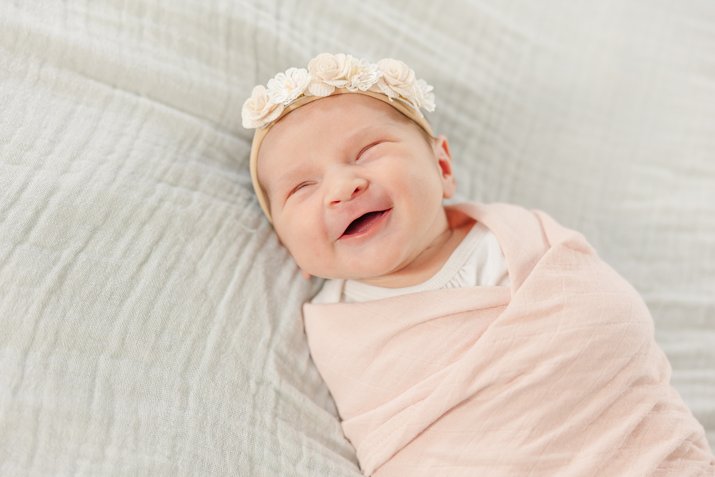 newborn girl smiles