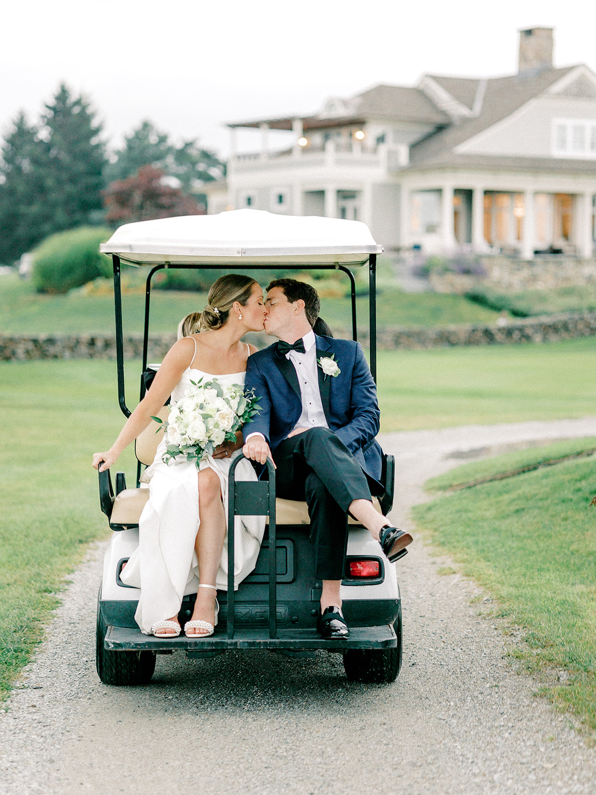 Bride and groom kiss at their New England country club wedding.