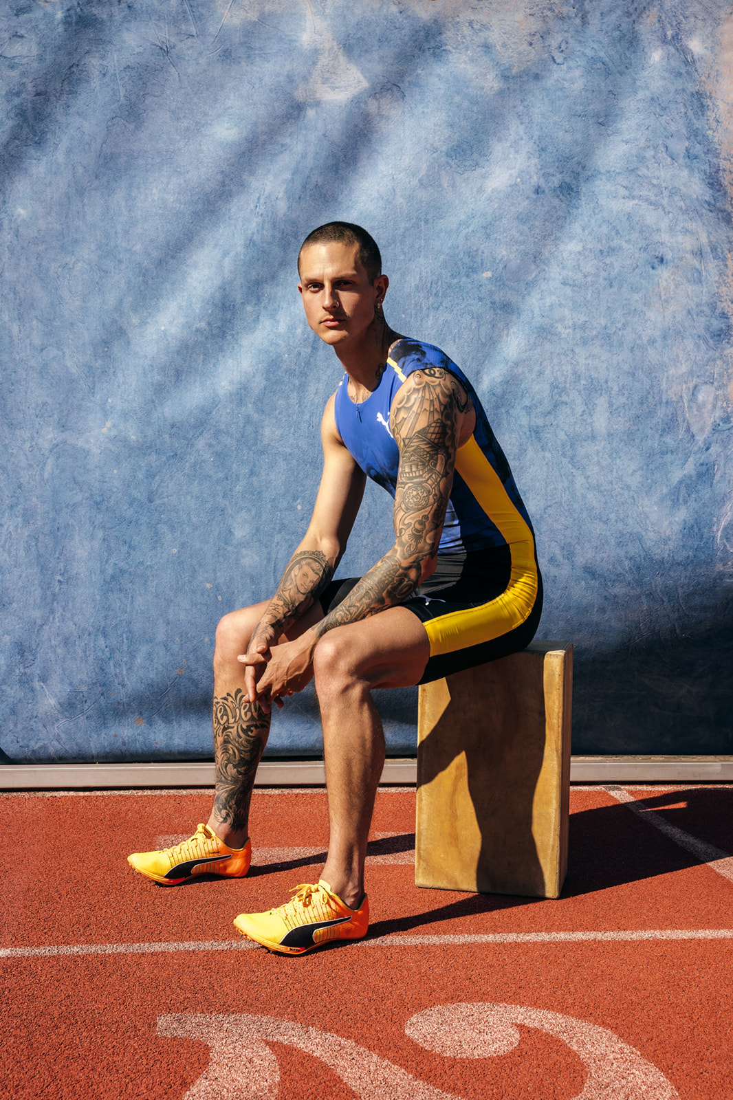 Paralympic Nick Mayhugh in front of blue hand painted canvas by Ultraviolet Backdrops. Image by Benny Renee Studios 