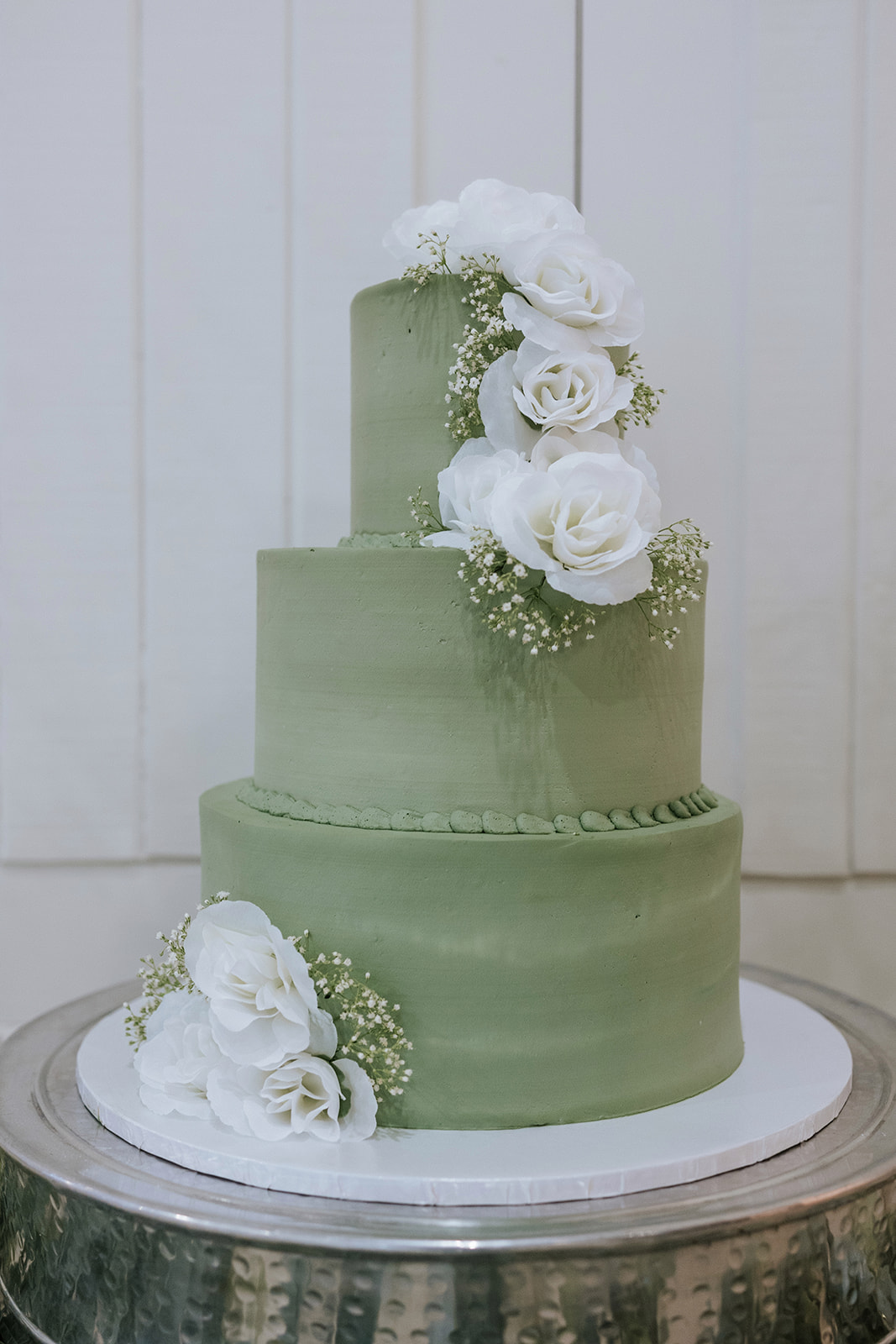 Beautiful Cake In green Color and White flowers.