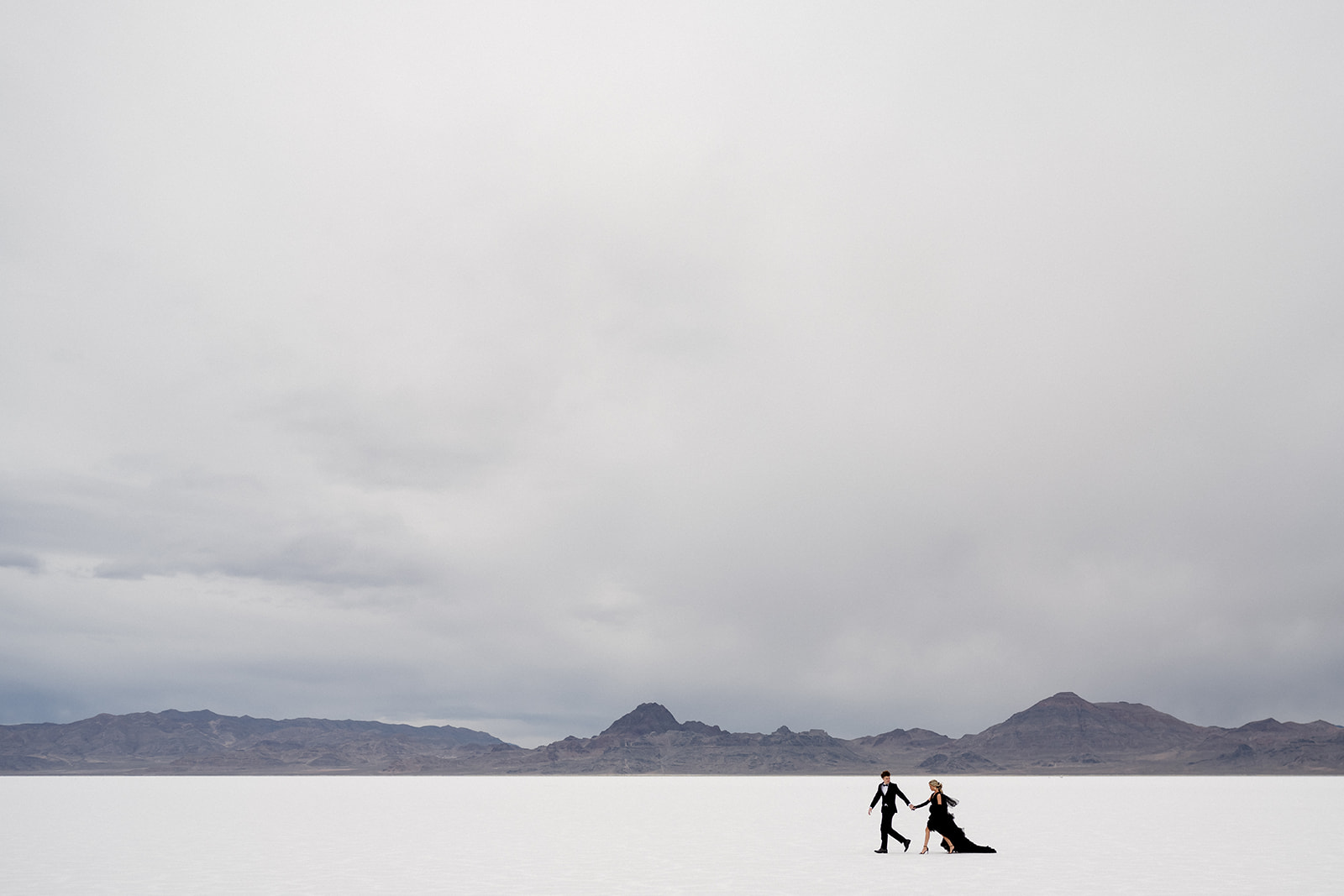 Bride and groom walk together in solitude at Utah Salt Flats wedding