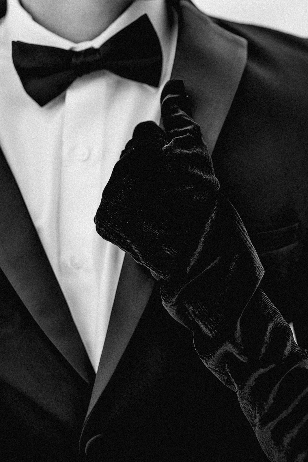 Close-up of couple’s hand holding the tux collar at Utah Salt Flats engagement session.
