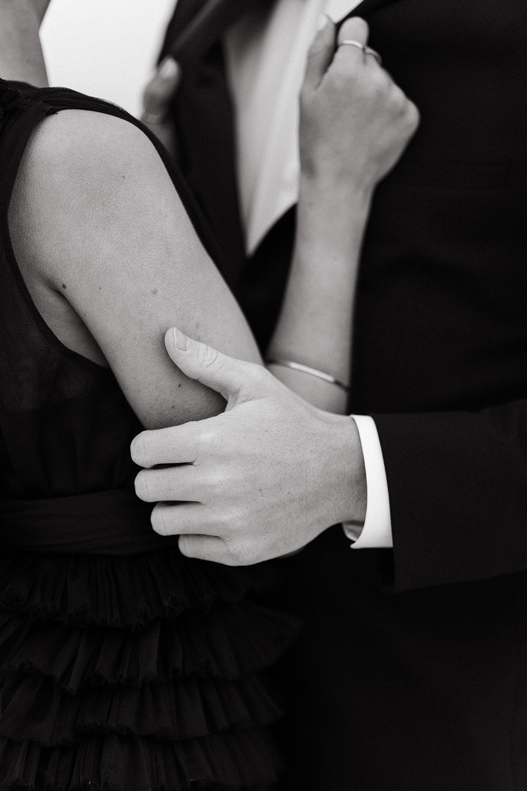 Close up on a black and white photo of a couple holding each other