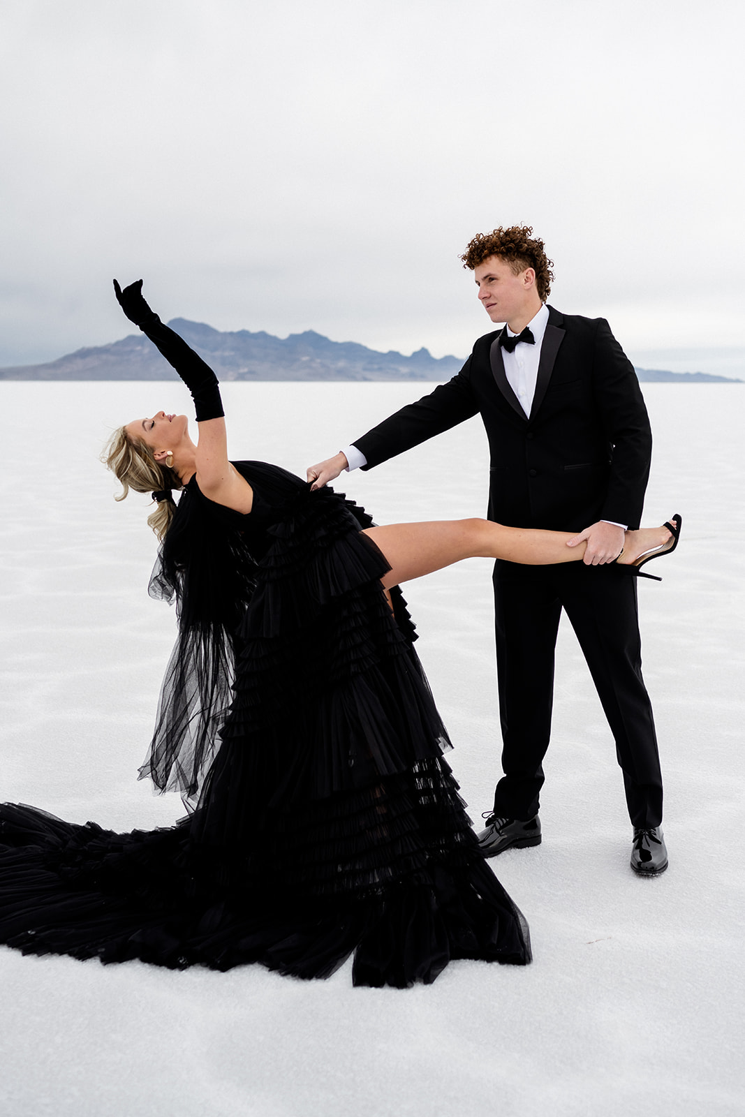 a couple dancing at Engagement session with a fun twist at the Utah Salt Flats by local photographer