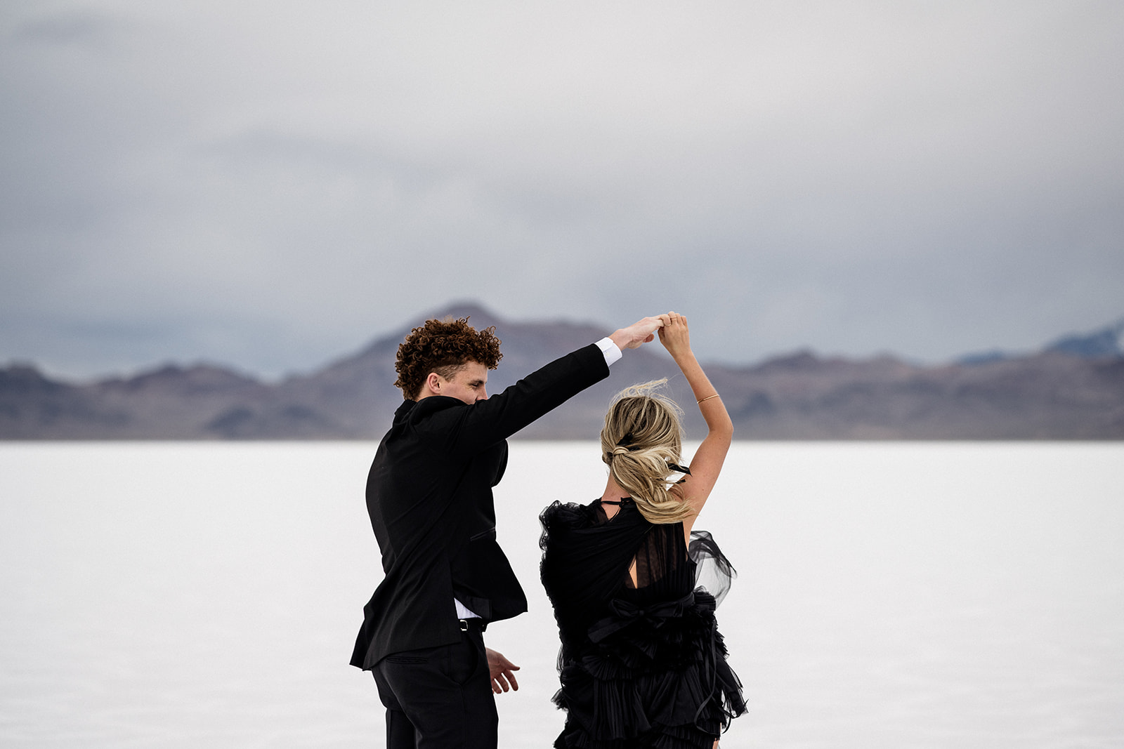 Dance of love captured during engagement session at Bonneville Salt Flats, Utah.