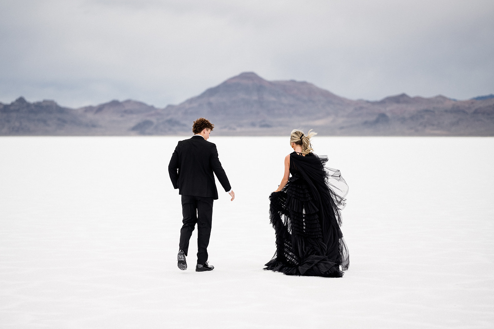 Elopement couple with just two at the vast Utah Salt Flats