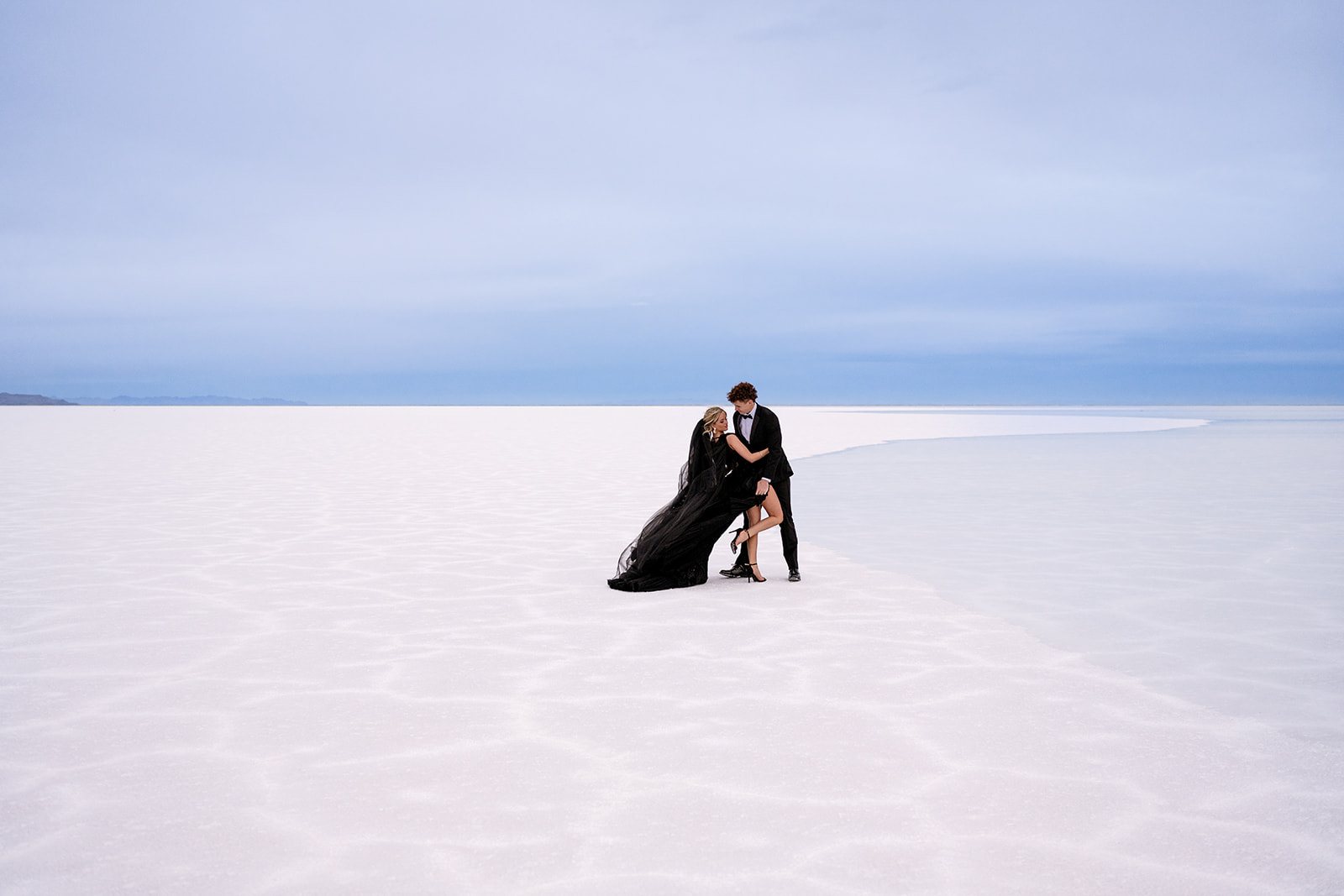 flooded Bonneville Salt Flats provide a dramatic scene for Utah couple’s session with water on the salt and blue sky