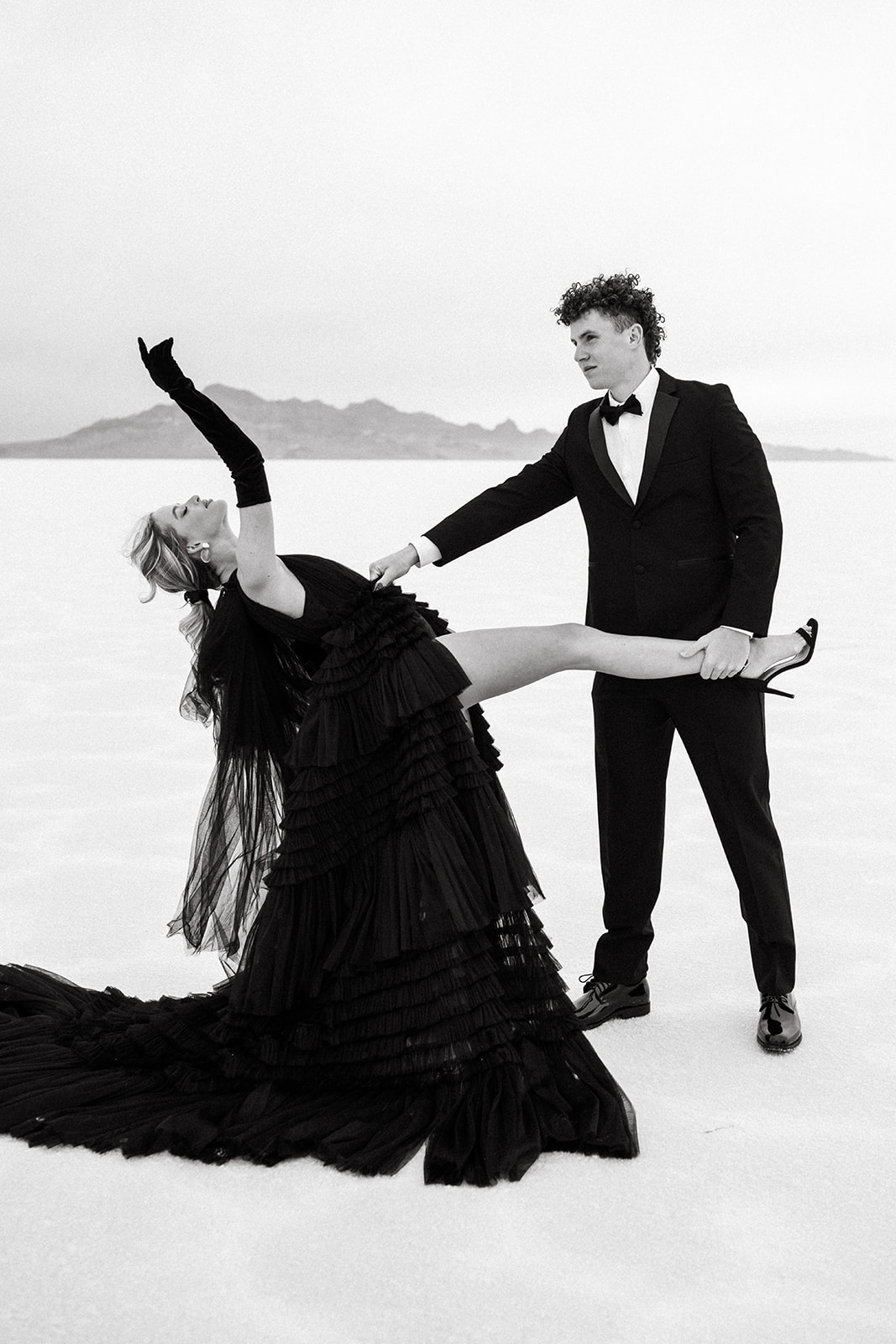 Stylish couple poses for engagement shoot on Utah’s ethereal Salt Flats