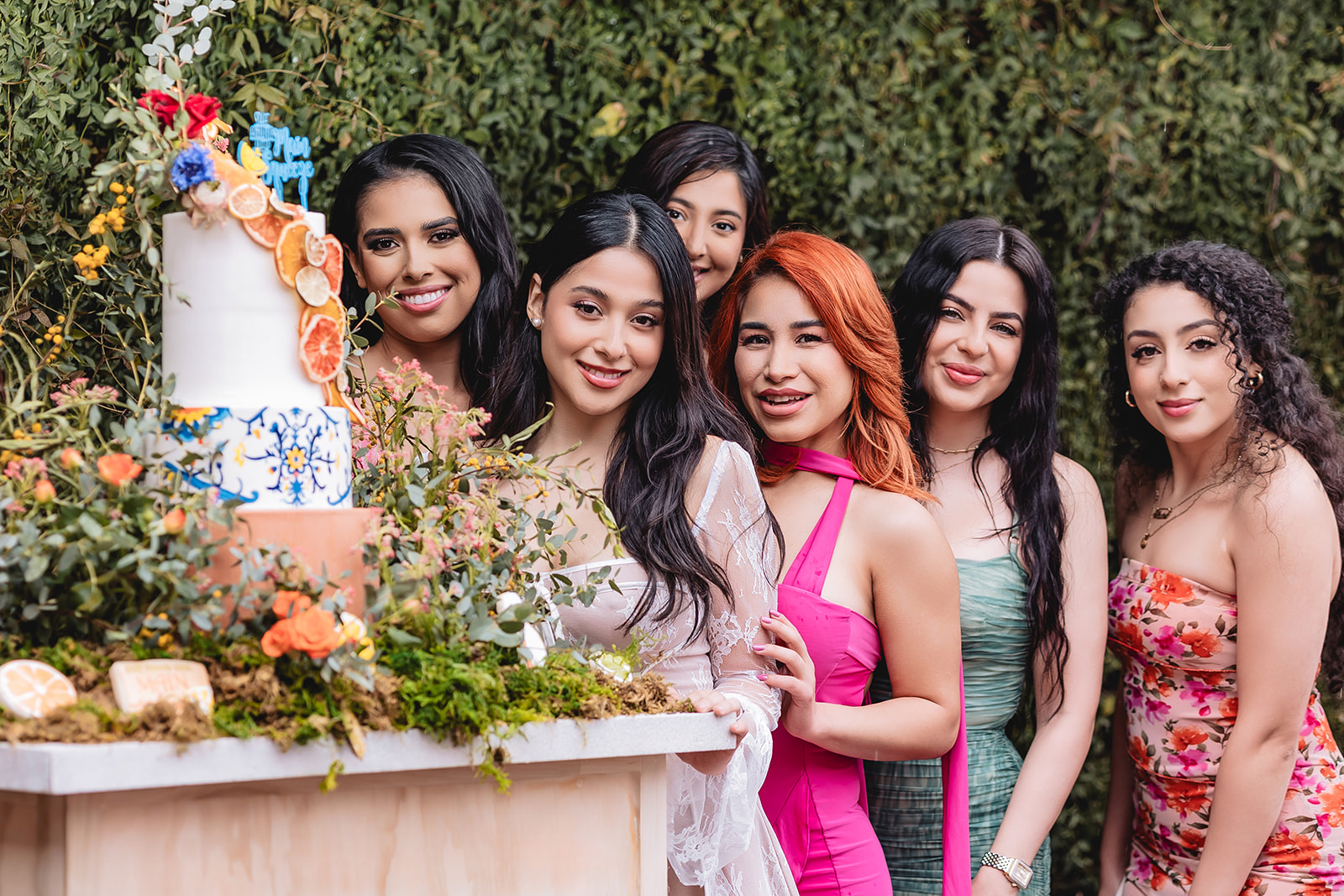 bridesmaid posing next to the wedding cake
