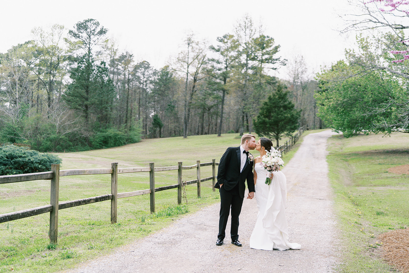 Bride and groom walk along the driveway at The Barn at Shady Lane in Birmingham, Alabama