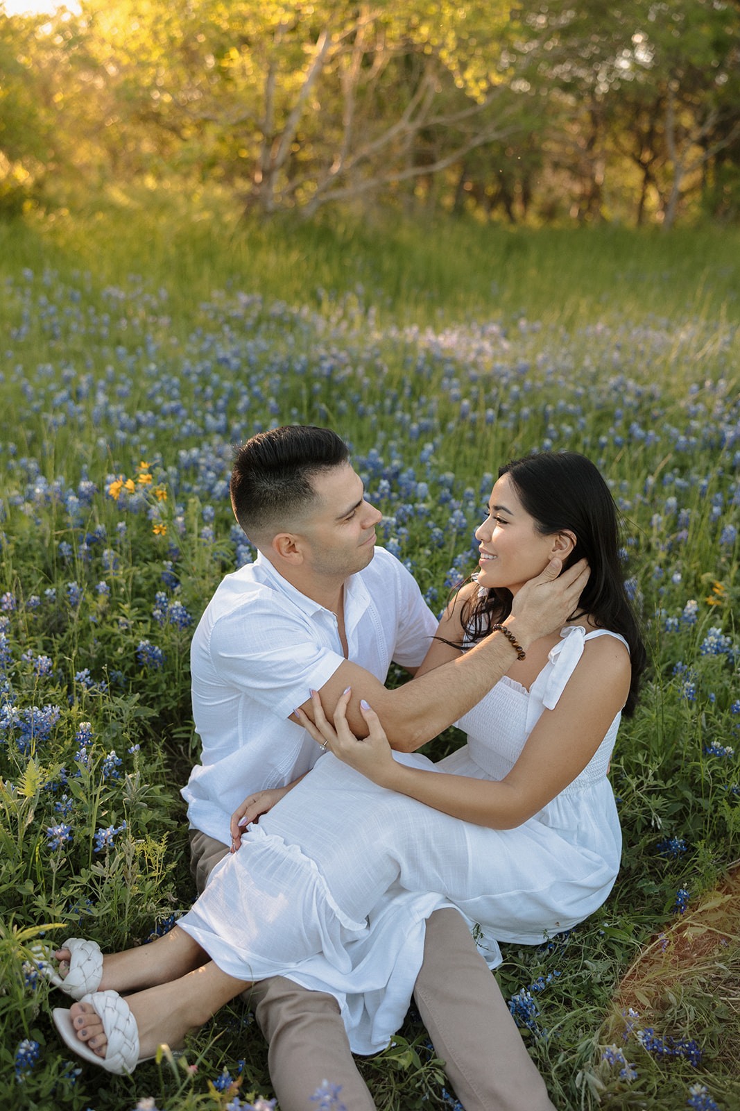 Couple sitting in field of Bluebonnets at McKinney Falls state park