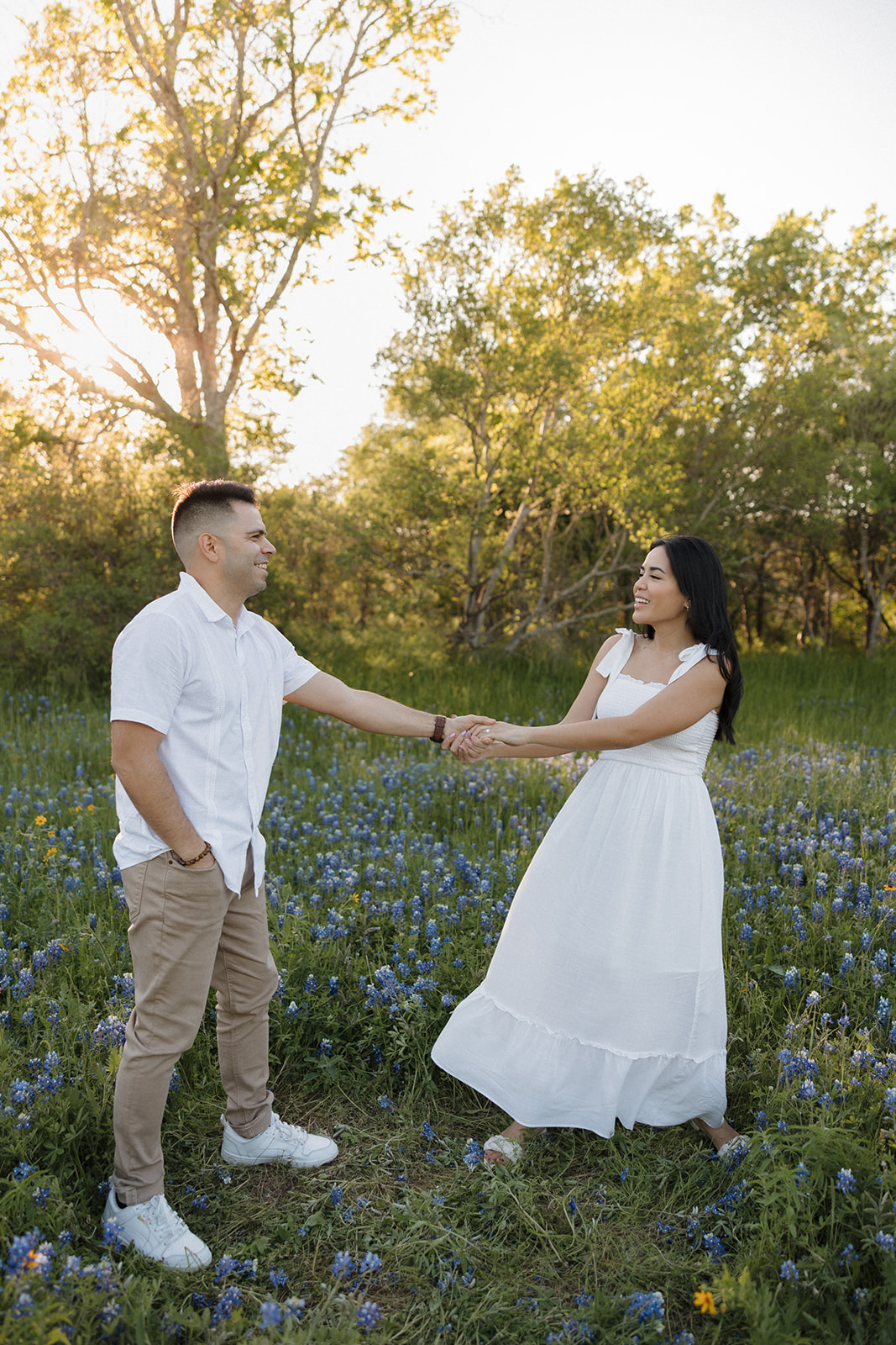 Couple walking in a field of Bluebonnets at McKinney Falls state park