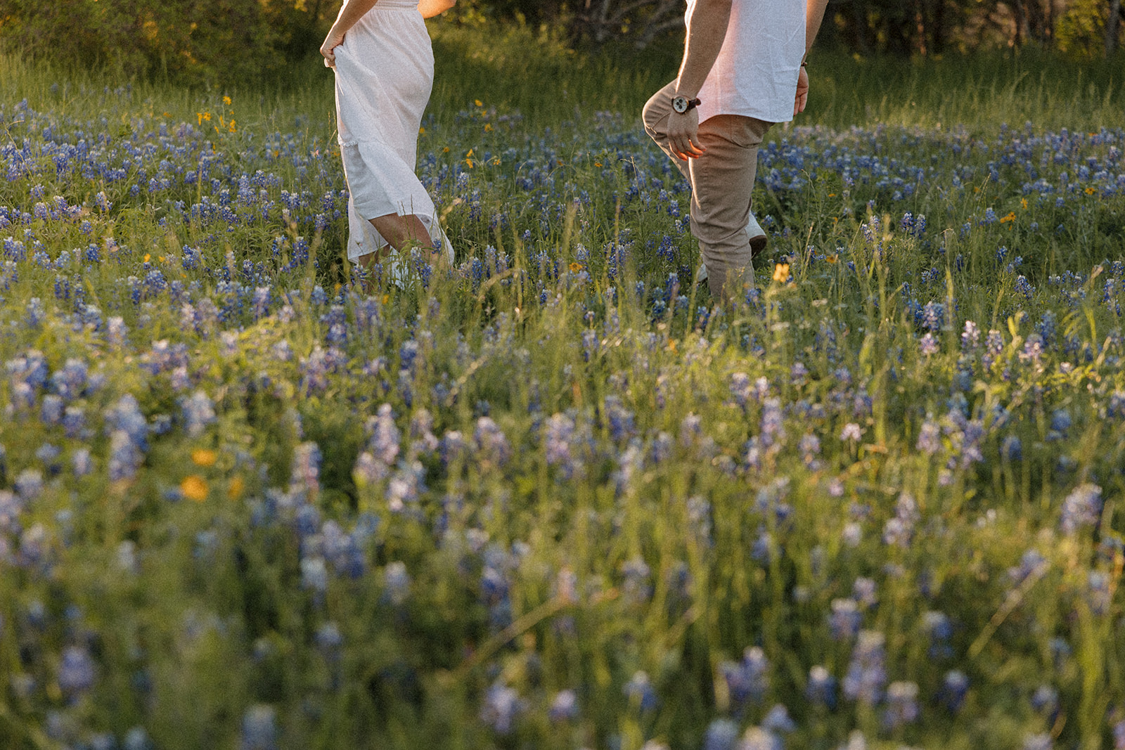 Couple walking in field of Bluebonnets at McKinney Falls state park