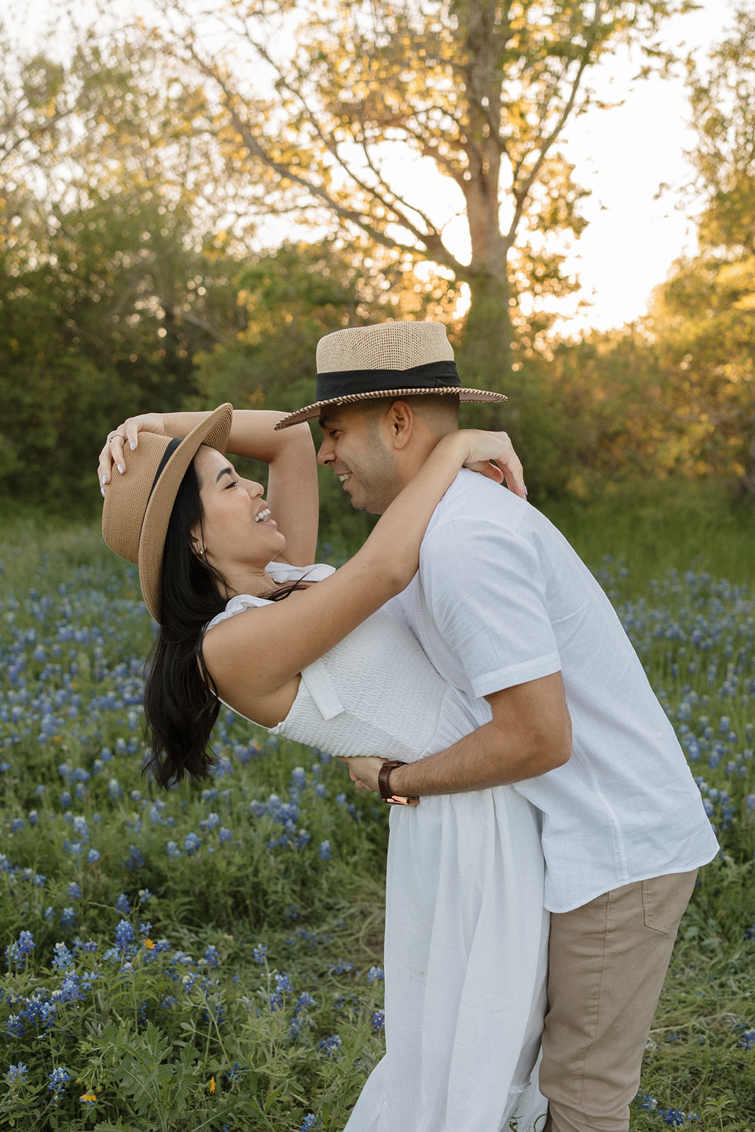 Couple dacning around in a field of Bluebonnets h at McKinney Falls state park