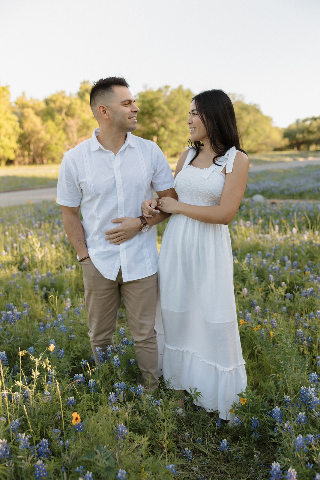 Couple walking in a field of Bluebonnets at McKinney Falls state park